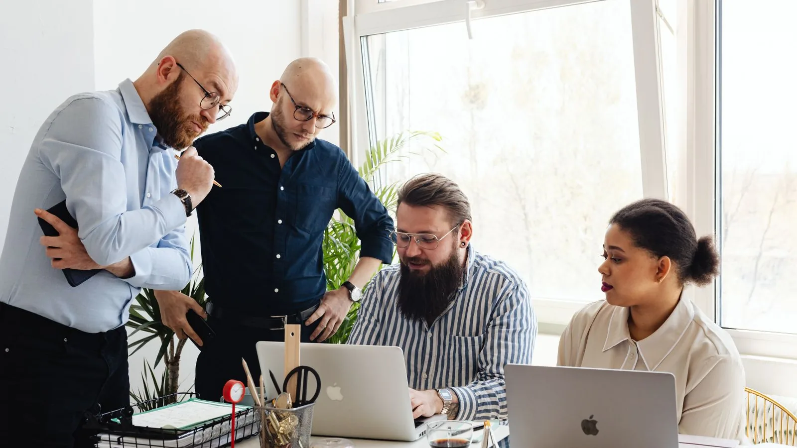 A team working together around laptops